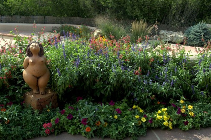 garden sculpture, colorful flowers, patio, flagstone, pool